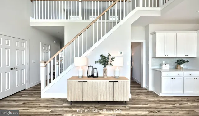 a view of entryway and hall with wooden floor