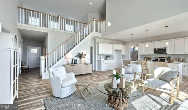a living room with furniture or kitchen view and a wooden floor