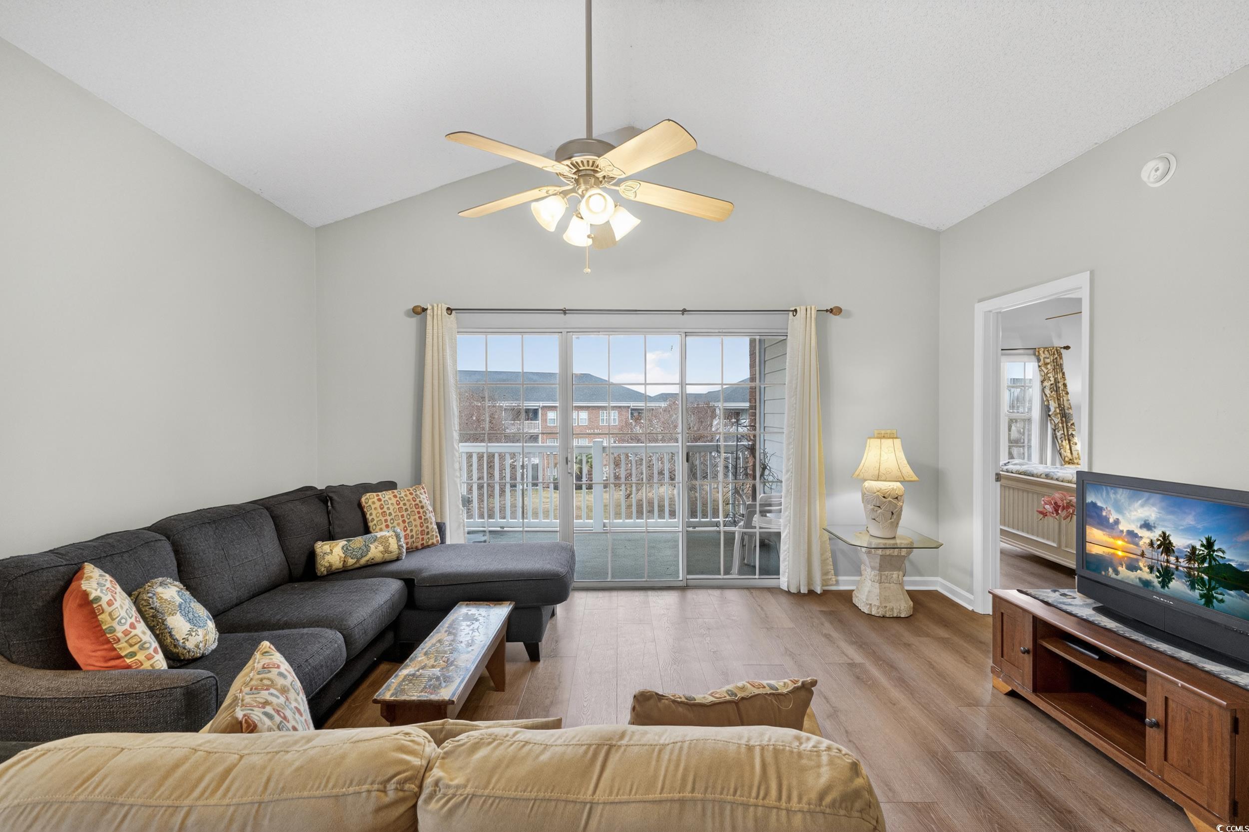 3915 Gladiola Court, Unit 301 Myrtle Beach, SC 29588 - Photo 11 of 24 Living area featuring vaulted ceiling, light wood finished floors, and ceiling fan