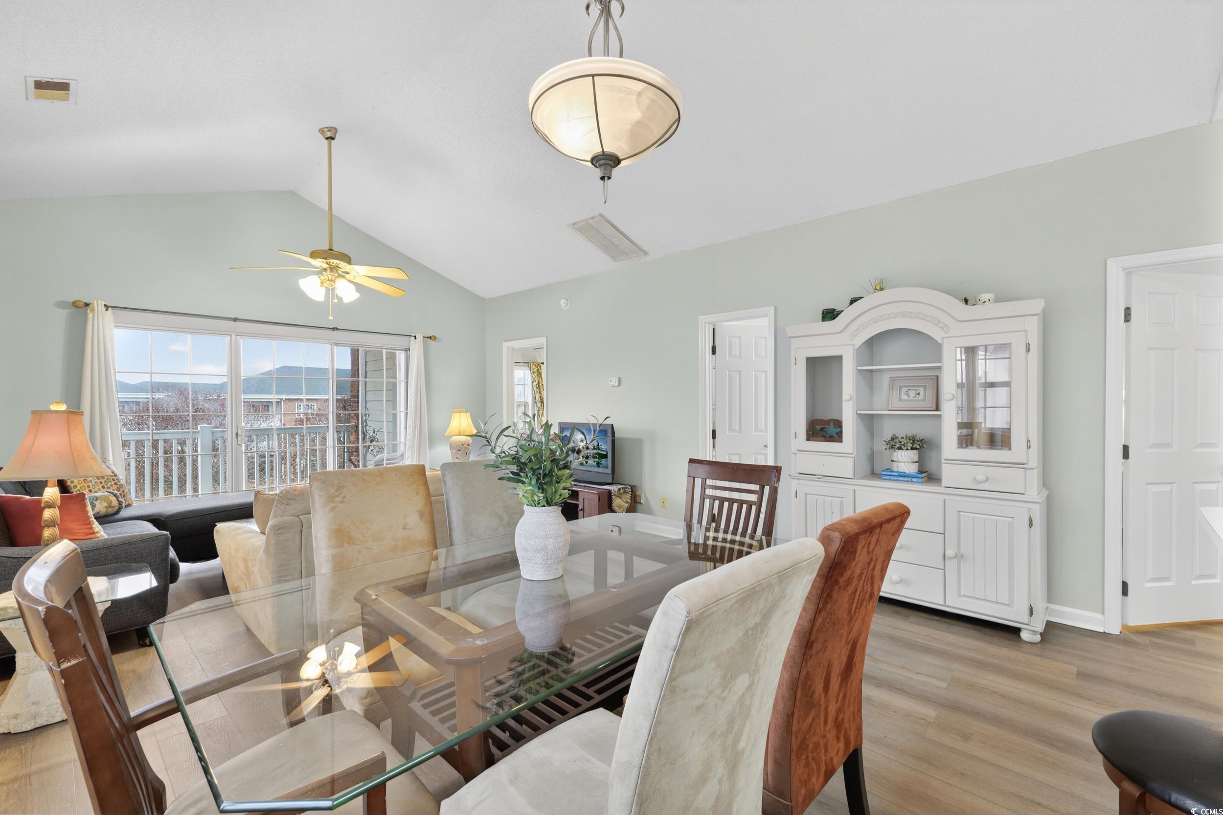 3915 Gladiola Court, Unit 301 Myrtle Beach, SC 29588 - Photo 12 of 24 Dining space with wood finished floors, ceiling fan, and lofted ceiling