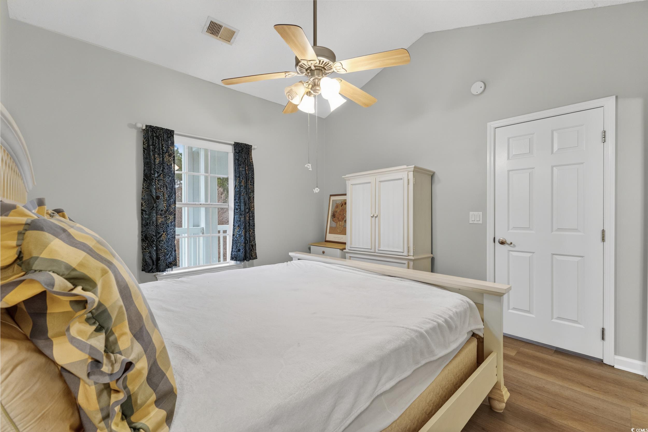 3915 Gladiola Court, Unit 301 Myrtle Beach, SC 29588 - Photo 17 of 24 Bedroom with vaulted ceiling, wood finished floors, and a ceiling fan