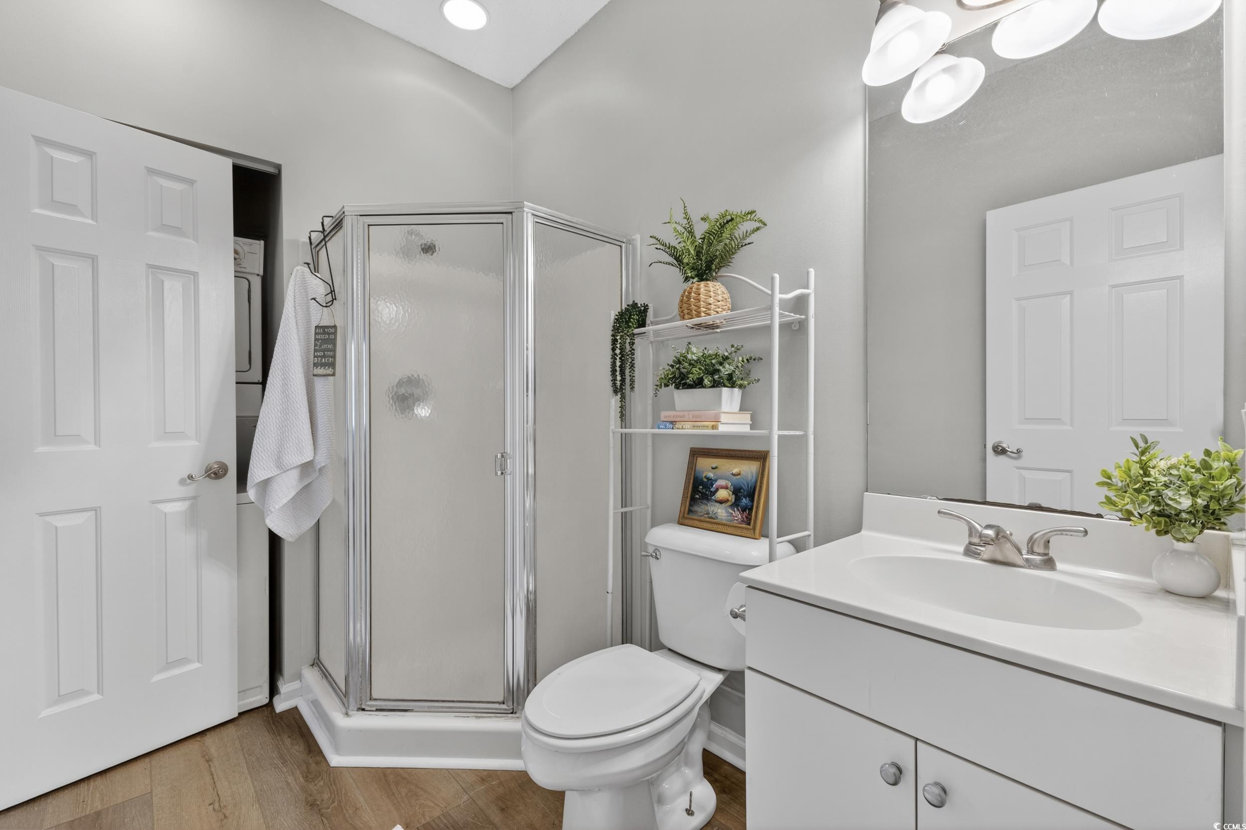 3915 Gladiola Court, Unit 301 Myrtle Beach, SC 29588 - Photo 18 of 24 Full bath featuring vanity, a shower stall, and wood finished floors