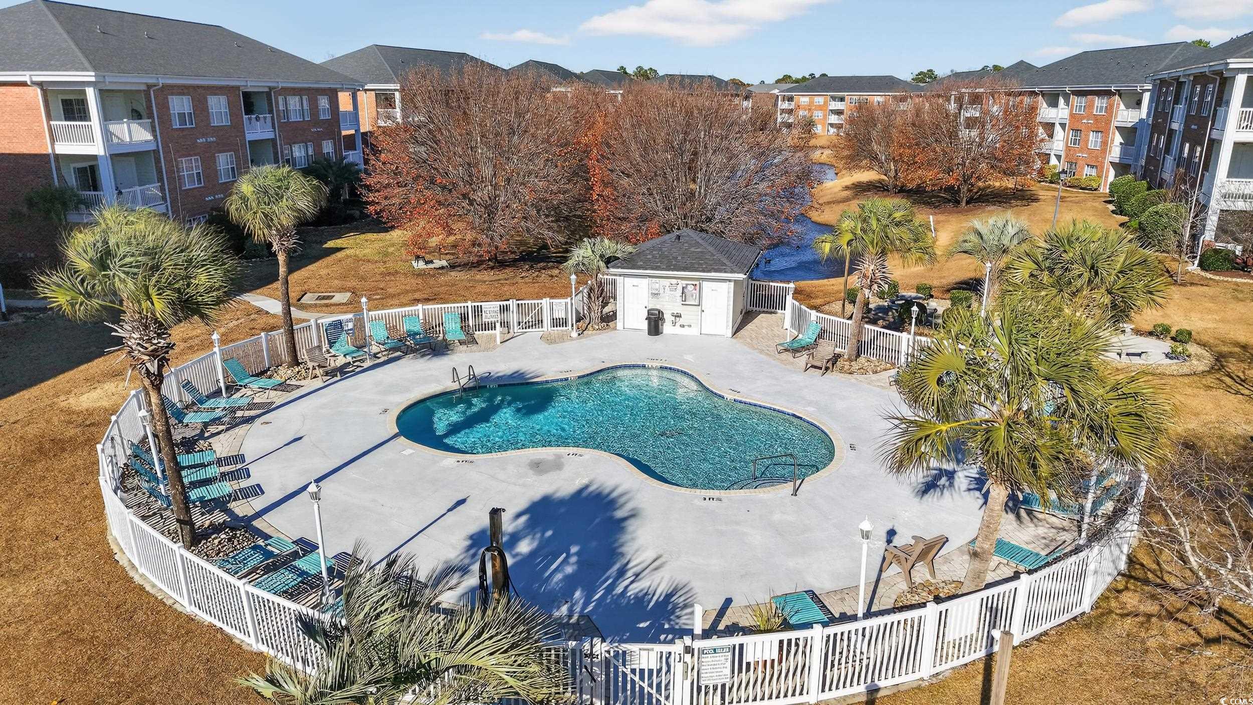 3915 Gladiola Court, Unit 301 Myrtle Beach, SC 29588 - Photo 21 of 24 Community pool featuring a patio and an outdoor structure