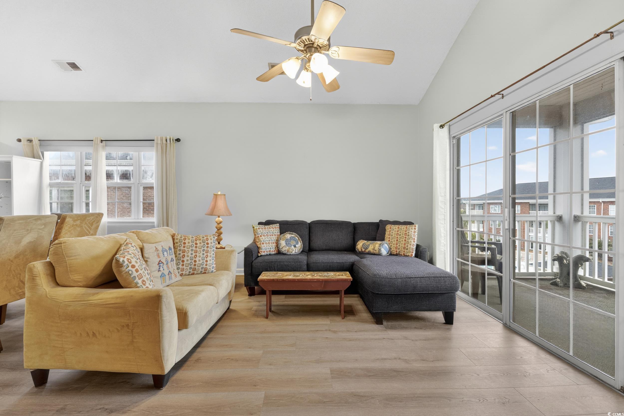 3915 Gladiola Court, Unit 301 Myrtle Beach, SC 29588 - Photo 9 of 24 Living area with lofted ceiling, light wood-type flooring, and ceiling fan