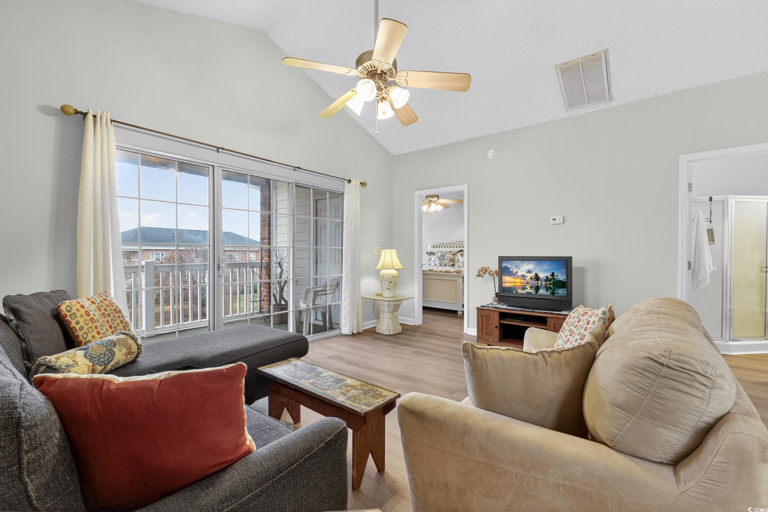 3915 Gladiola Court, Unit 301 Myrtle Beach, SC 29588 - Photo 10 of 24 Living area with a ceiling fan, high vaulted ceiling, and wood finished floors