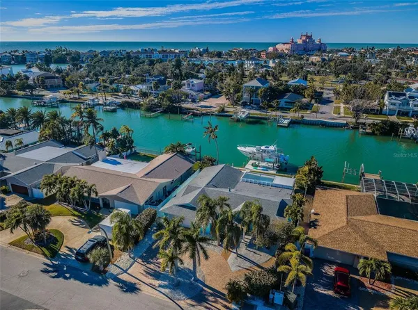 an aerial view of a house with a garden and lake view