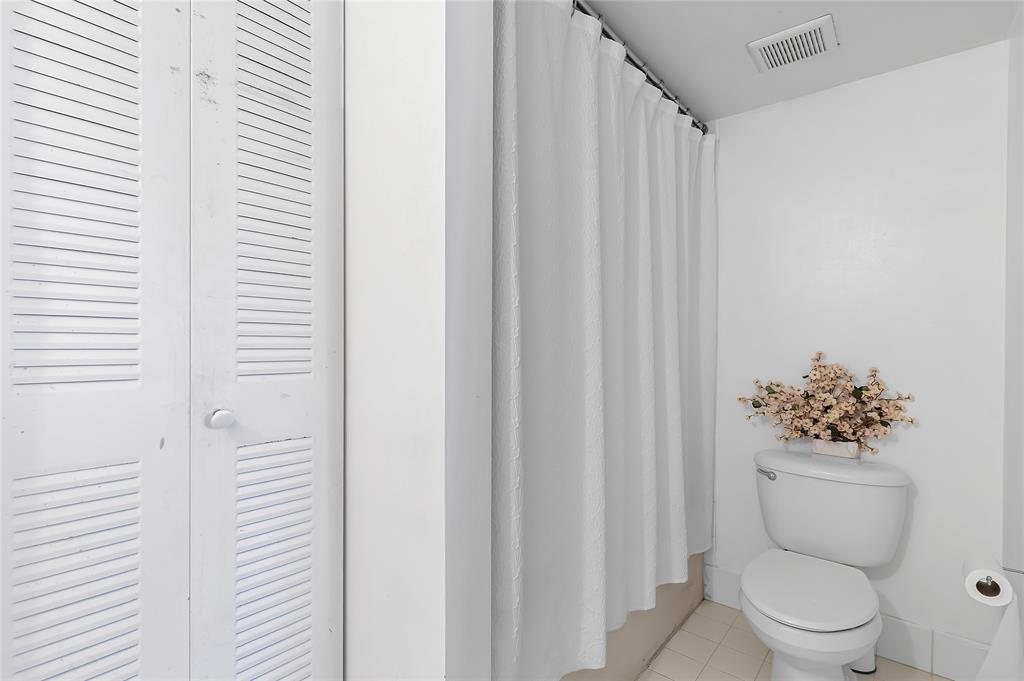 2133 Renaissance Boulevard, Unit 205 Miramar, FL 33025 - Photo 12 of 24 a bathroom with a toilet and a shower curtain