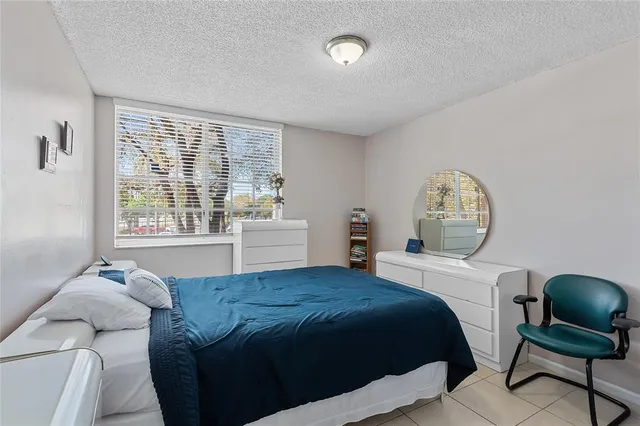 a bedroom with a bed and a table in it