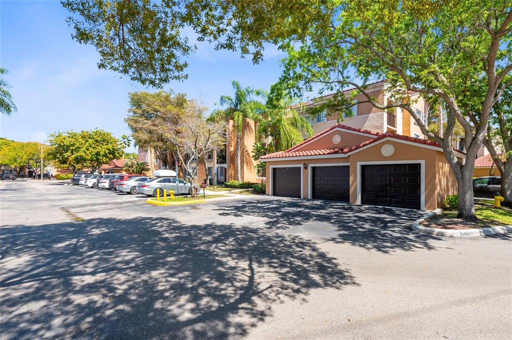2133 Renaissance Boulevard, Unit 205 Miramar, FL 33025 - Photo 21 of 24 a view of a house with cars parked in front of a house