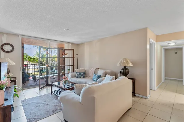 a living room with furniture and a floor to ceiling window