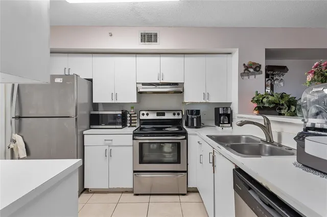a kitchen with a sink stove and refrigerator