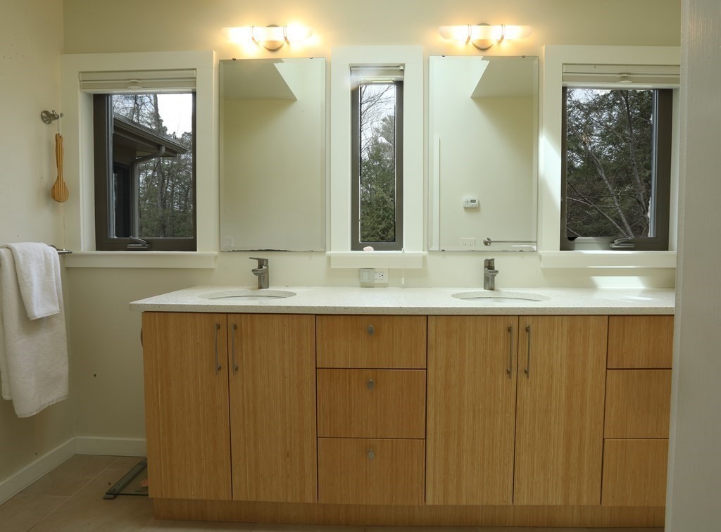18 Willow Road Harvard, MA 01451 - Photo 16 of 35 a bathroom with a double vanity sink mirror and a bathtub