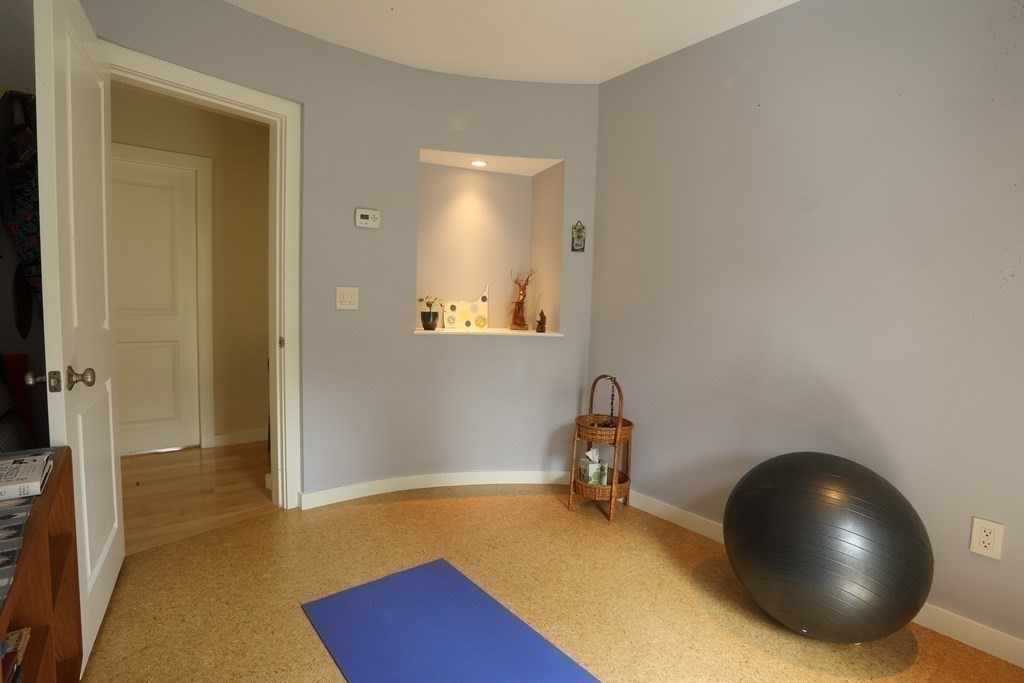 18 Willow Road Harvard, MA 01451 - Photo 20 of 35 a room with a wooden floor and a potted plant