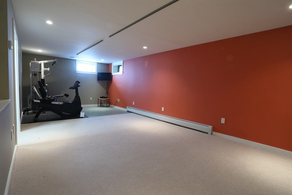 18 Willow Road Harvard, MA 01451 - Photo 26 of 35 an empty room with furniture and a car parked