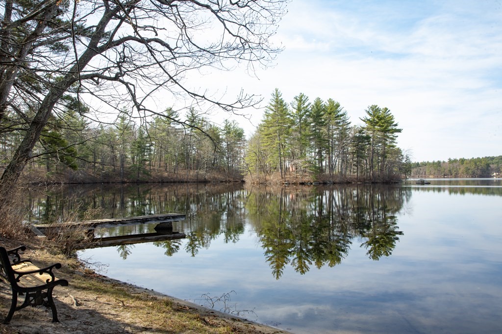 18 Willow Road Harvard, MA 01451 - Photo 35 of 35 a wooden bench sitting next to a lake