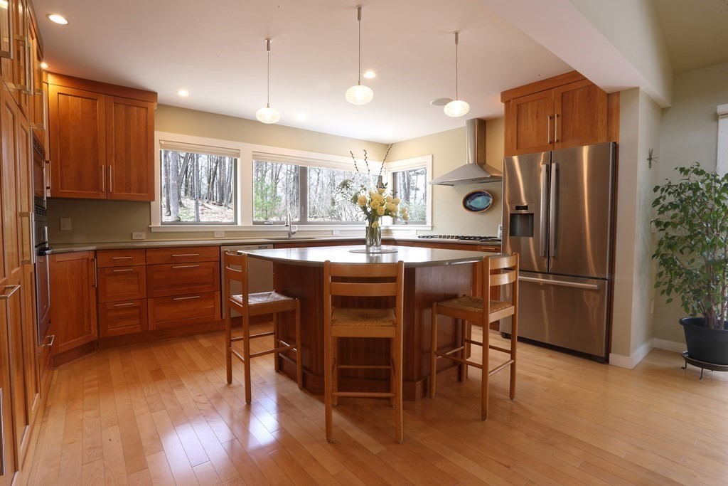18 Willow Road Harvard, MA 01451 - Photo 8 of 35 a kitchen with refrigerator cabinets dining table and chairs