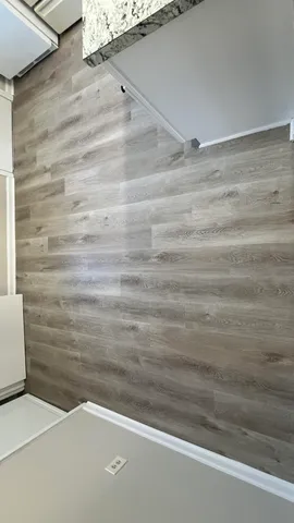 a kitchen with granite countertop a refrigerator stove a sink and dishwasher with wooden floor