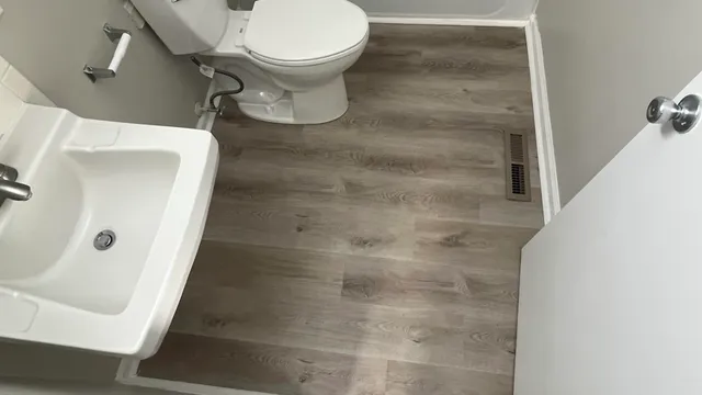 a bathroom with a toilet and a shower