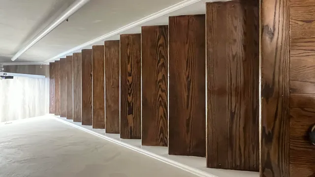 a view of a closet with wooden walls