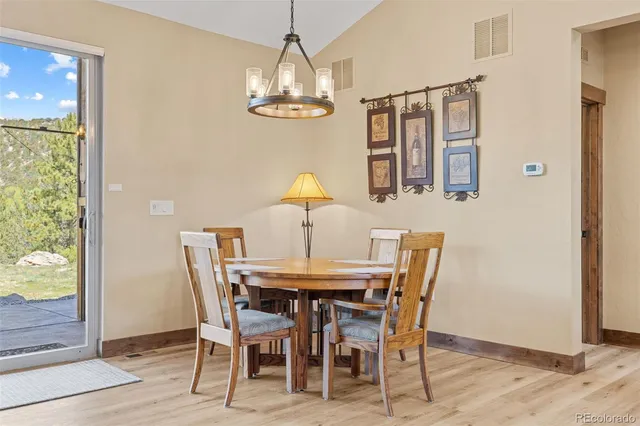 a view of a dining room with furniture and chandelier