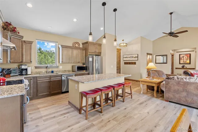 a kitchen that has a lot of cabinets in it and appliances