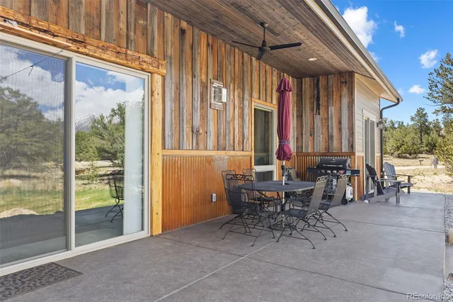 a view of a patio with table and chairs and potted plants