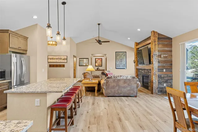 a living room with fireplace furniture and a wooden floor