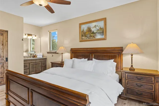 a bedroom with a bed and a lamp on dresser