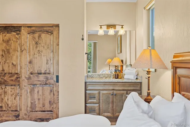 a bathroom with a sink vanity mirror and toilet