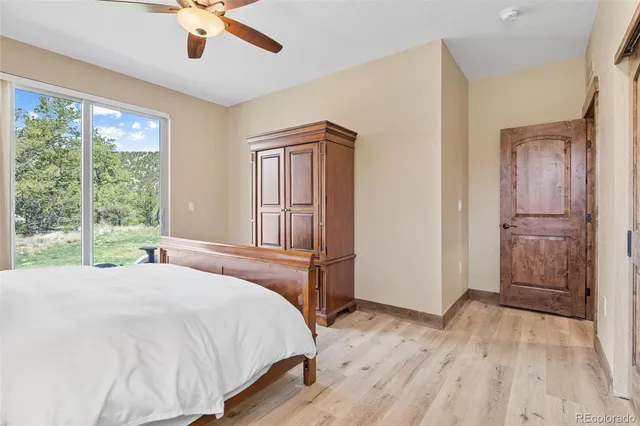 a bedroom with a bed dresser and a window