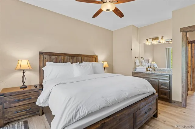 a bedroom with bed and a chandelier