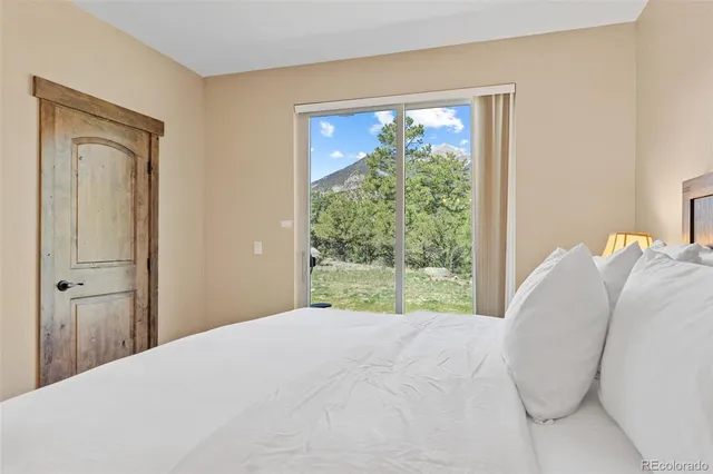 a bedroom with a bed and a large window