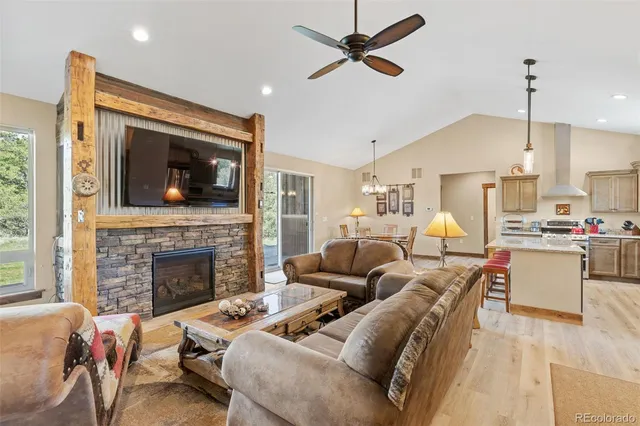 a living room with furniture a fireplace and a flat screen tv