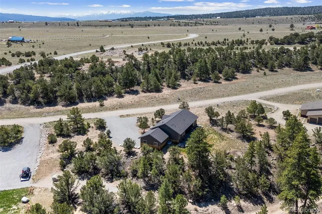 an aerial view of a houses with a lake view