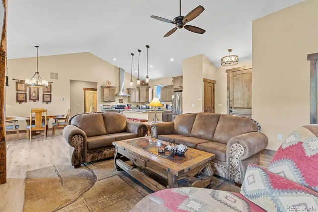 a living room with furniture a rug and white walls