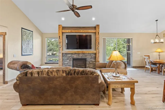 a living room with fireplace furniture and a flat screen tv