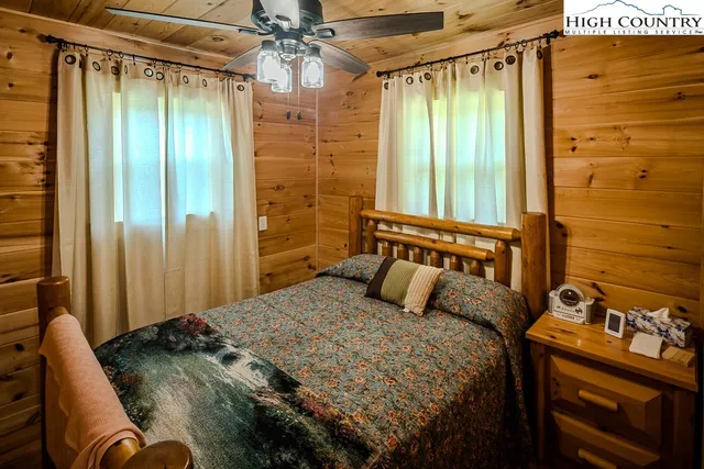 a bed sitting in a bedroom next to a bathroom