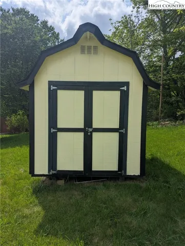 a view of a garden with a house in the background