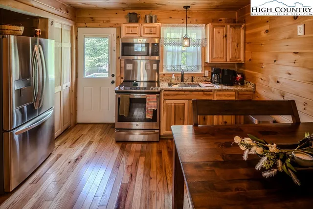 a kitchen with counter top space and wooden floor