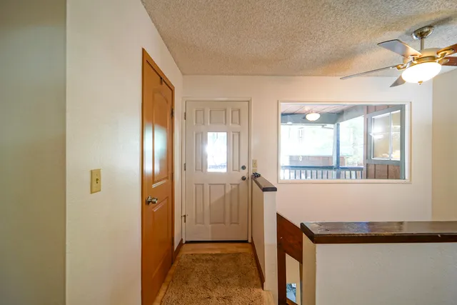 a dining room with furniture a chandelier and wooden floor