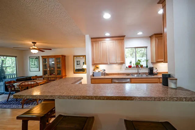 a large kitchen with kitchen island a large counter top