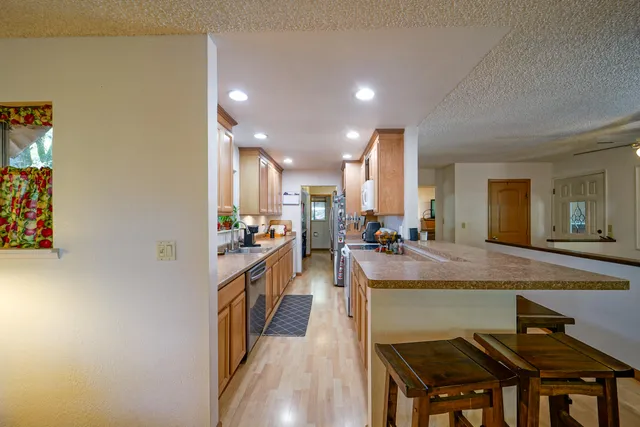 a living room with furniture a dining table and wooden floor