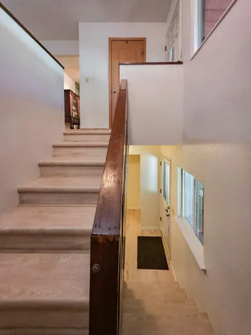 a bathroom with a granite countertop toilet sink and mirror