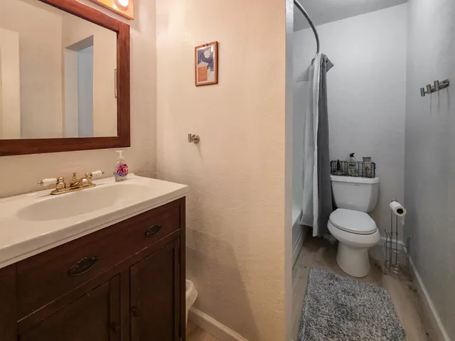 a view of a storage & utility room with closet wooden floor and windows