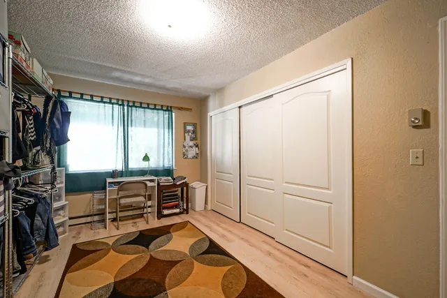 a view of a street with wooden fence