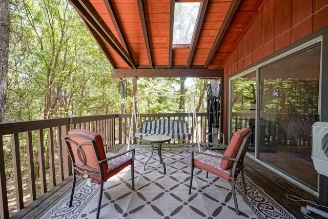 a view of house with backyard and trees