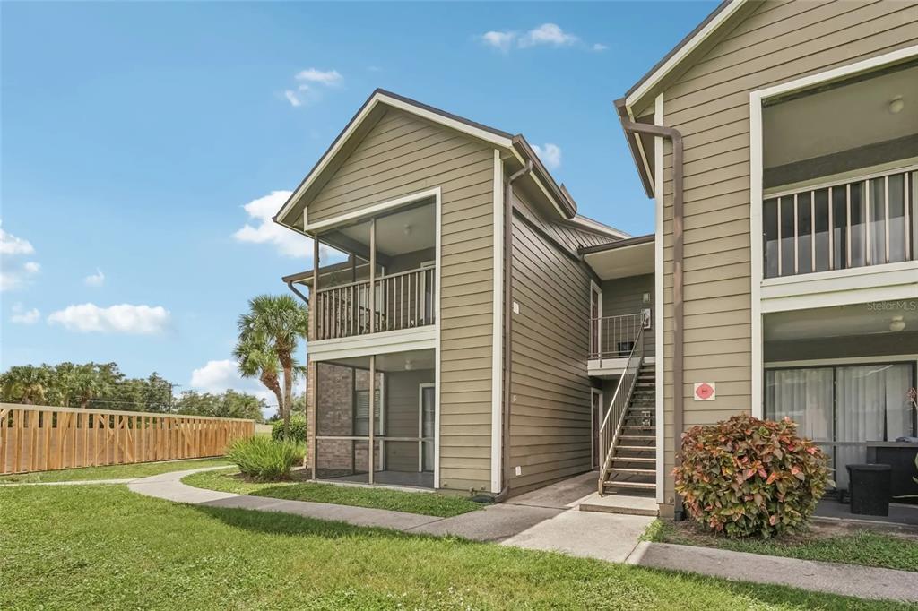 a front view of house with a garden