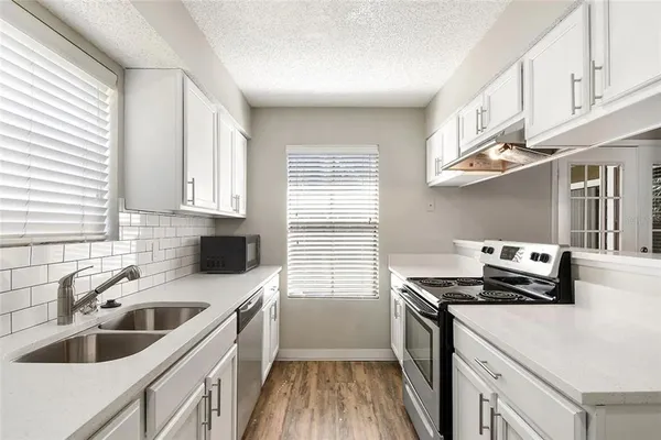 a kitchen that has a sink and a stove