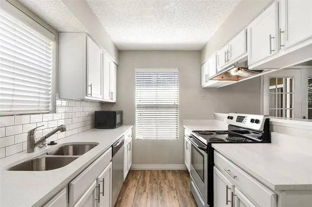 a kitchen that has a sink and a stove