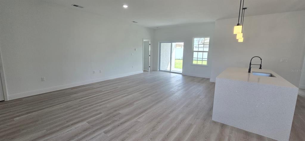 4464 Southwest 132nd Street Ocala, FL 34473 - Photo 3 of 17 a view of an empty room with window and wooden floor